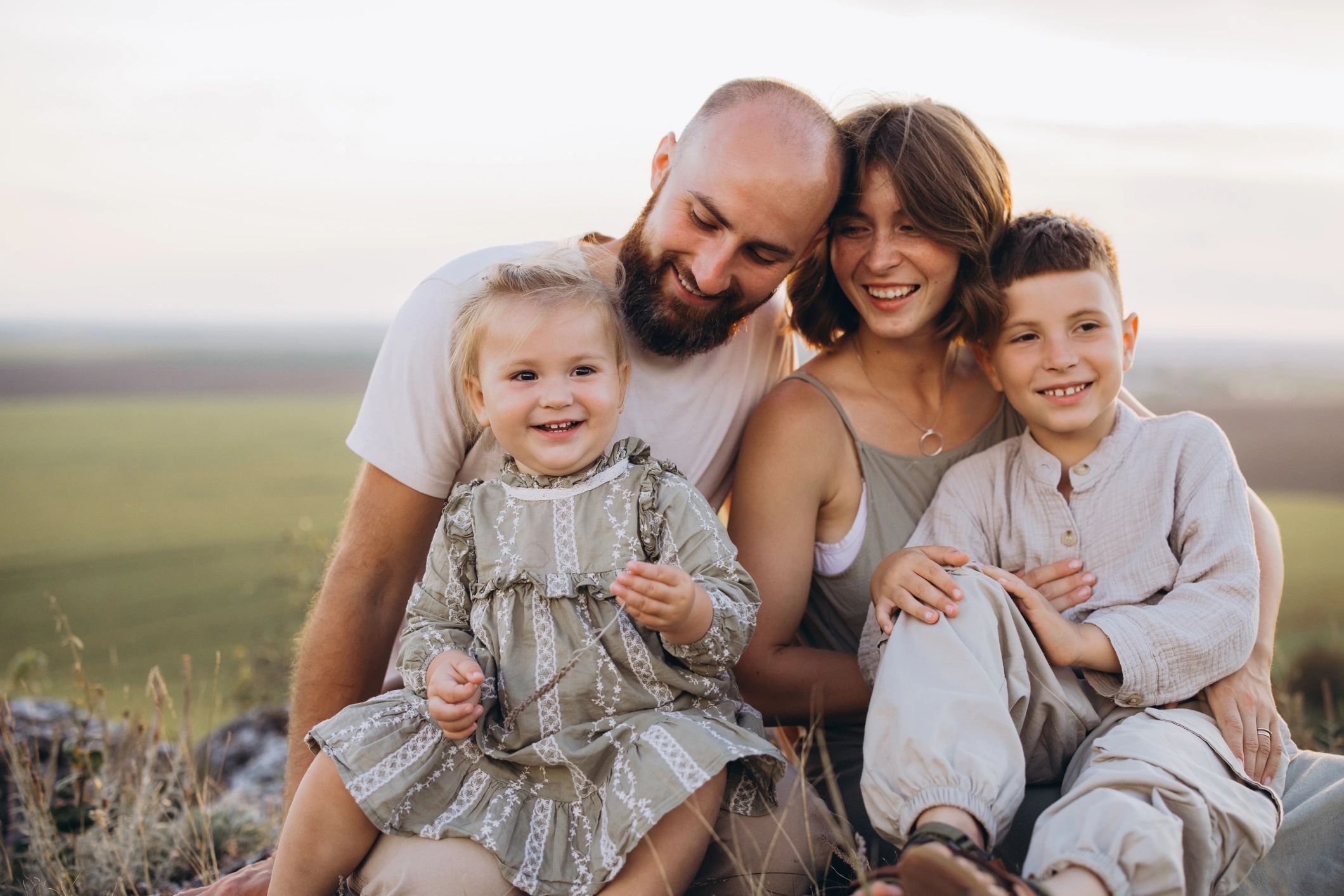 Family enjoying an outdoor portrait session at sunset